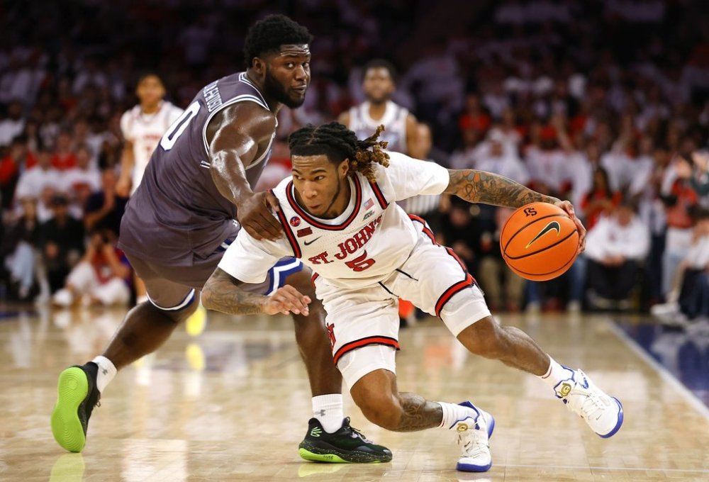 St. John's guard Deivon Smith (5) is fouled by Seton Hall guard Dylan Addae-Wusu (0) during the second half of an NCAA college basketball game, Saturday, March 1, 2025, in New York. (AP Photo/Noah K. Murray)