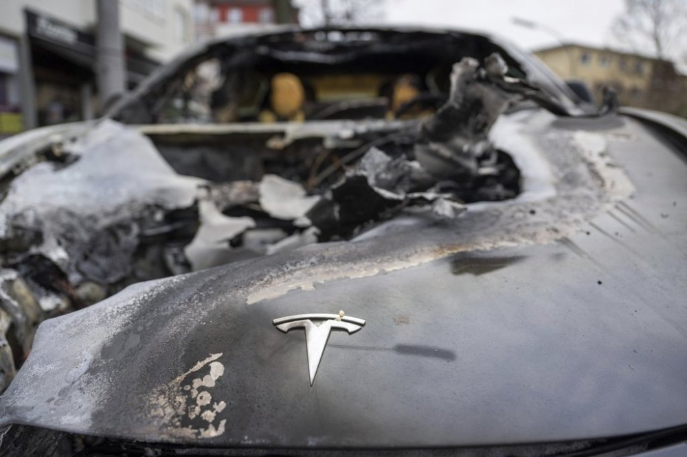 A burnt-out Tesla car stands in the Steglitz district of Berlin, Friday, March 14, 2025. CANADIAN PRESS/AP/Christophe Gateau