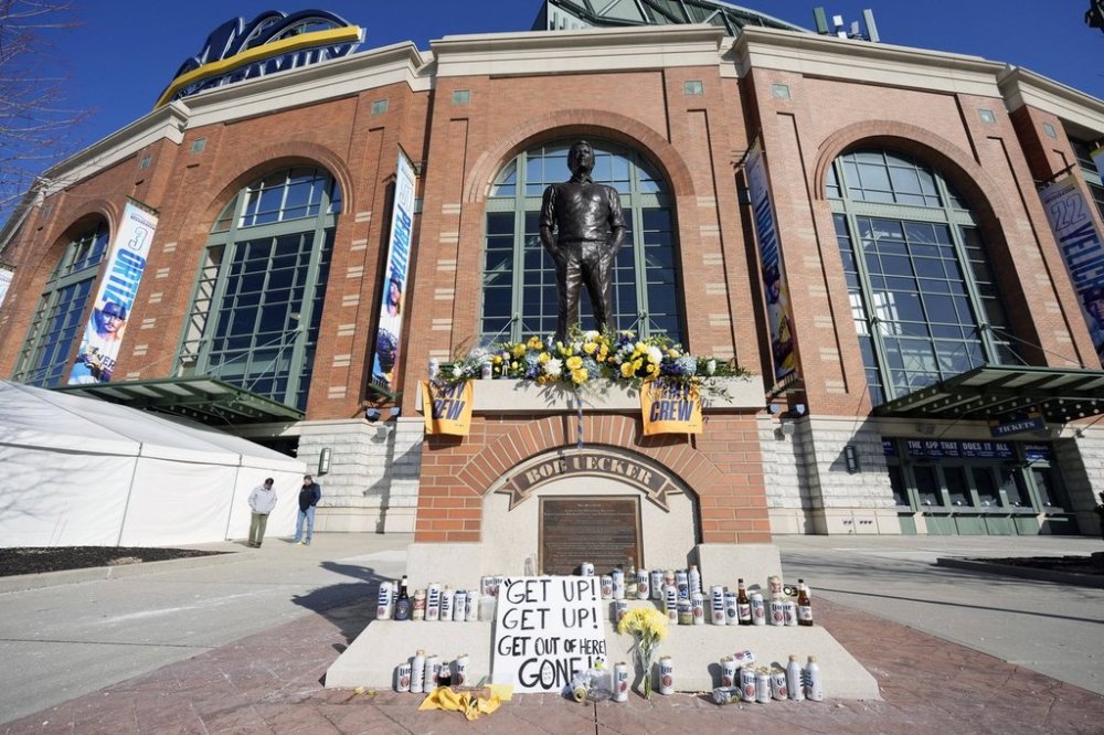 Cans and bottle of beer, along with other items, adorn the base of the the Bob Uecker statue in front of American Family Field following a baseball game between the Milwaukee Brewers and the Kansas City Royals on Opening Day, Monday, March 31, 2025, in Milwaukee. (AP Photo/Kayla Wolf)