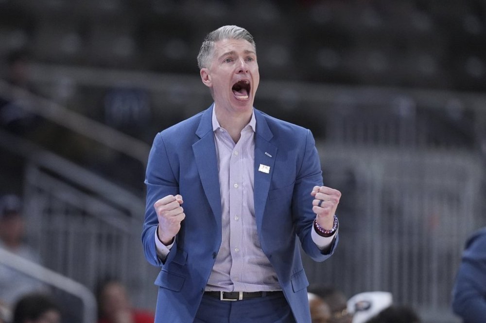 Robert Morris head coach Andrew Toole celebrates in the second half of an NCAA college basketball game in the championship of the Horizon League tournament against Youngstown State in Indianapolis, Tuesday, March 11, 2025. (AP Photo/Michael Conroy)
