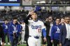Los Angeles Dodgers' Shohei Ohtani waves to fans as he walks off the field after the team's MLB Tokyo Series baseball game against the Chicago Cubs in Tokyo, Japan, Wednesday, March 19, 2025. (AP Photo/Eugene Hoshiko)