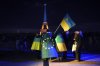 FILE - Ukrainians hold Ukrainian and European flag as the Eiffel Tower is illuminated with the colors of Ukraine to mark the third anniversary of Russia's invasion of the country, in Paris, Feb. 24, 2025. (AP Photo/Christophe Ena, file)