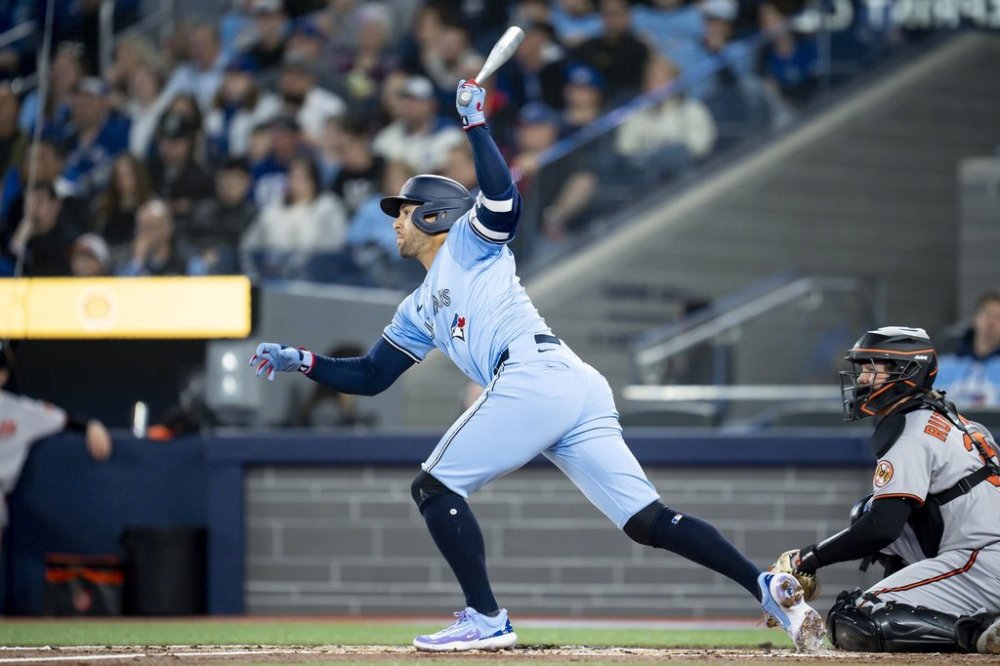 Toronto Blue Jays outfielder George Springer (4) hits a two-run single during first inning MLB baseball action against the Baltimore Orioles in Toronto on Sunday, March 30, 2025. THE CANADIAN PRESS/Christopher Katsarov