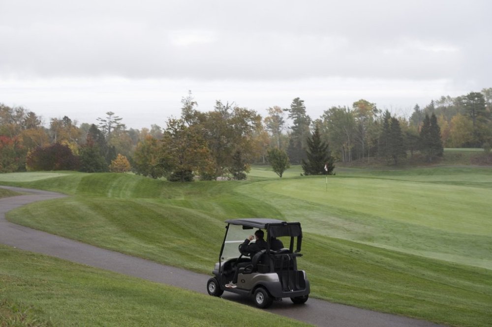 A golf cart rolls on the path off the Manoir Richelieu golf course, Sunday October 6, 2024 in Pointe-au-Pic Que. THE CANADIAN PRESS/Jacques Boissinot