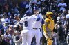Chicago Cubs' Kyle Tucker, center, and Ian Happ (8) celebrate after scoring on Tucker's two-run home run during the second inning of a baseball game against the San Diego Padres, Sunday, April 6, 2025, in Chicago. (AP Photo/Matt Marton)