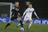 Arsenal's Chloe Kelly, left is chased by Real Madrid's Olga Carmona during the Women's Champions League quarterfinal first leg soccer match between Real Madrid and Arsenal at the Alfredo di Stefano stadium in Madrid, Spain, Tuesday March 18, 2025. (AP Photo/Fran Berg)