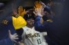 Milwaukee Brewers' Eric Haase is congratulated in the dugout after hitting a solo home run during the third inning of a baseball game against the Kansas City Royals, Tuesday, April 1, 2025, in Milwaukee. (AP Photo/Aaron Gash)