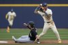 Milwaukee Brewers shortstop Joey Ortiz, right, holds the ball after forcing out Chicago White Sox's Brooks Baldwin, left, at second base during the fourth inning of a spring training baseball game Wednesday, March 5, 2025, in Phoenix. (AP Photo/Ross D. Franklin)