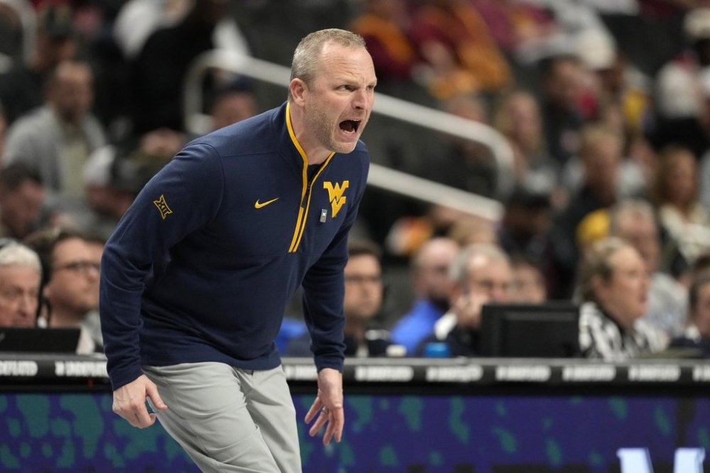 West Virginia head coach Darian Devries yells from the sidelines during the first half of an NCAA college basketball game against the Colorado in the second round of the Big 12 Conference tournament, Wednesday, March 12, 2025, in Kansas City, Mo. (AP Photo/Charlie Riedel)