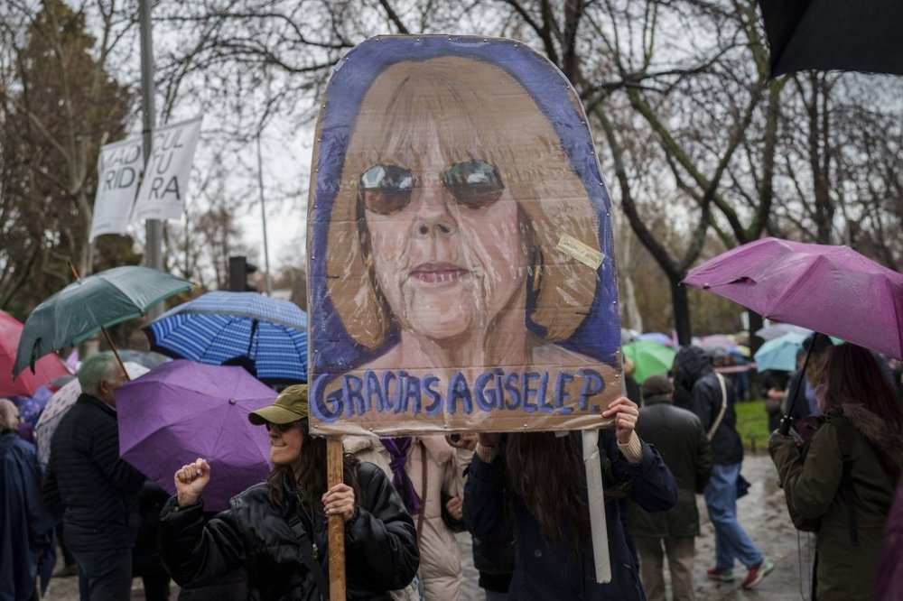 Demonstrators hold a poster depicting Gisele Pélicot during an International Women's Day protest in Madrid, Spain, Saturday, March 8, 2025. (AP Photo/Bernat Armangue)