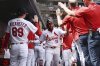 St. Louis Cardinals' Victor Scott II (11) celebrates with teammates after hitting a two-run home run during the third inning of a baseball game Sunday, March 30, 2025, in St. Louis. (AP Photo/Michael Thomas)