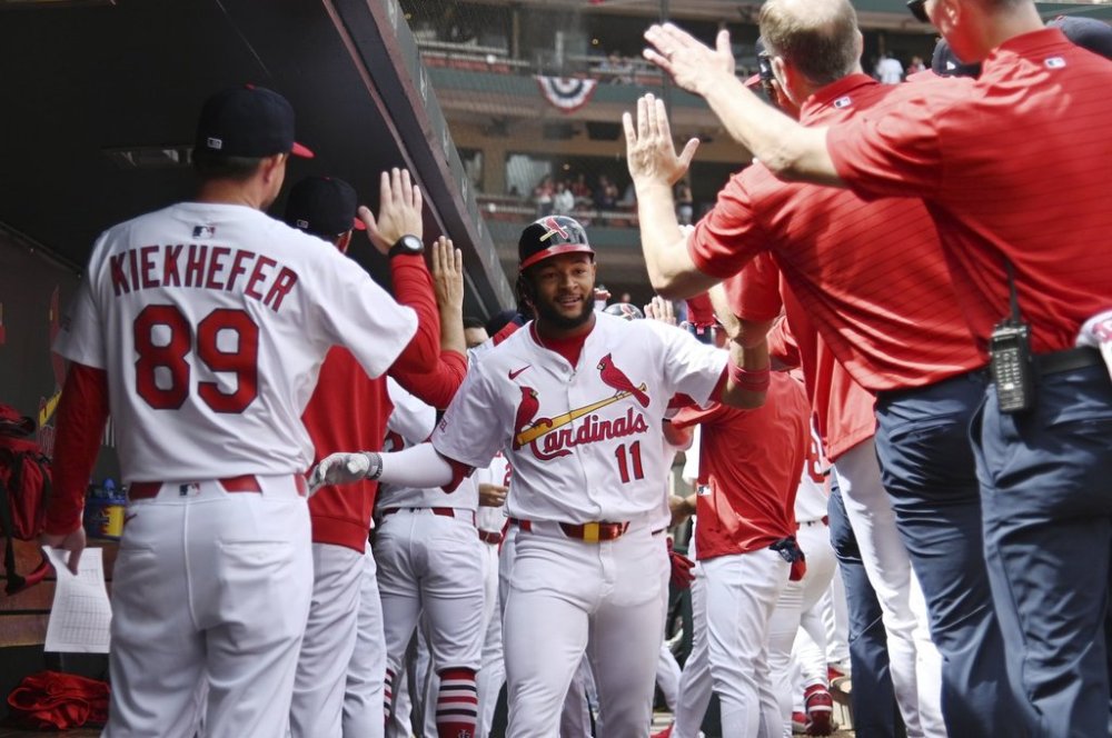 St. Louis Cardinals' Victor Scott II (11) celebrates with teammates after hitting a two-run home run during the third inning of a baseball game Sunday, March 30, 2025, in St. Louis. (AP Photo/Michael Thomas)