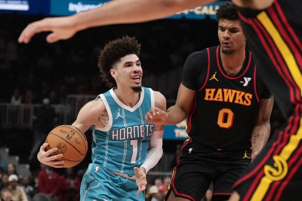 Charlotte Hornets guard LaMelo Ball (1) dribbles against Atlanta Hawks forward Dominick Barlow (0) in the first half of an NBA basketball game, Wednesday, March 12, 2025, in Atlanta. (AP Photo/Brynn Anderson)