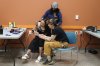 Rachel Recollet, left, sits with staff members  during a 