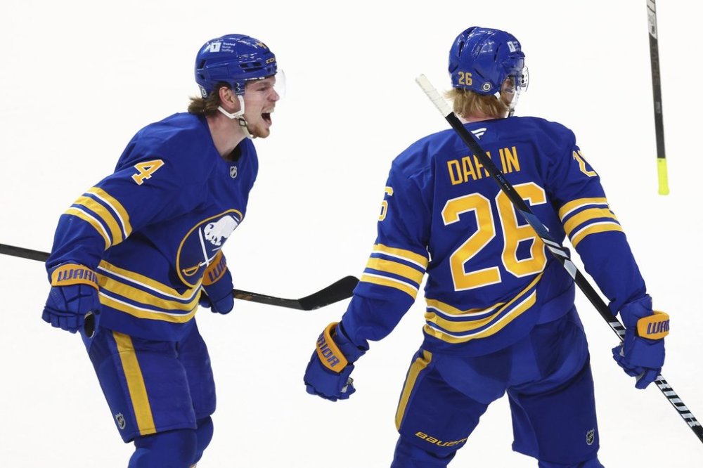 Buffalo Sabres defenseman Rasmus Dahlin (26) celebrates his goal with defenseman Bowen Byram (4) during the third period of an NHL hockey game against the Vegas Golden Knights, Saturday, March 15, 2025, in Buffalo, N.Y. (AP Photo/Jeffrey T. Barnes)