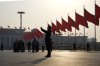 A man takes photos near red flags on Tiananmen Square before the closing session of the Chinese People's Political Consultative Conference (CPPCC) in Beijing, Sunday, March 10, 2024. THE CANADIAN PRESS/AP-Ng Han Guan