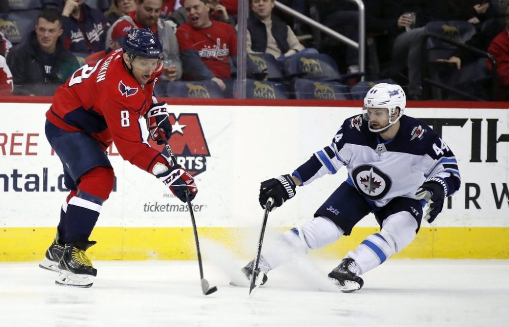 Washington Capitals left wing Alex Ovechkin (8) tries to shoot past Winnipeg Jets defenceman Josh Morrissey (44) in the third period of an NHL hockey game, Monday, March 12, 2018, in Washington. (AP Photo/Alex Brandon)