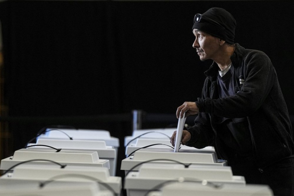 A man casts his vote in parliamentary elections in Nuuk, Greenland, Tuesday, March 11, 2025. (AP Photo/Evgeniy Maloletka)
