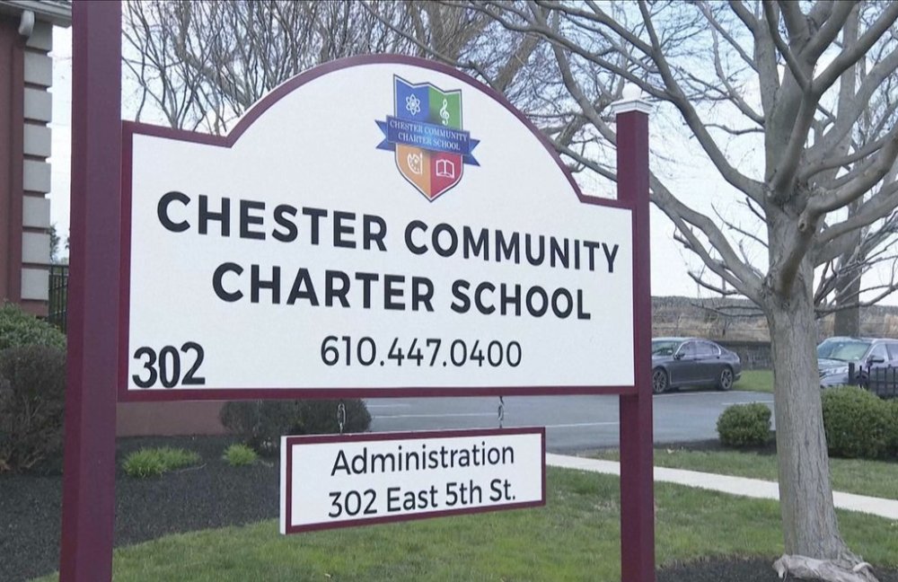A sign stands outside the Chester Community Charter School on Monday, March 31, 2025, in Chester, Pa. (AP Photo/Mingson Lau)