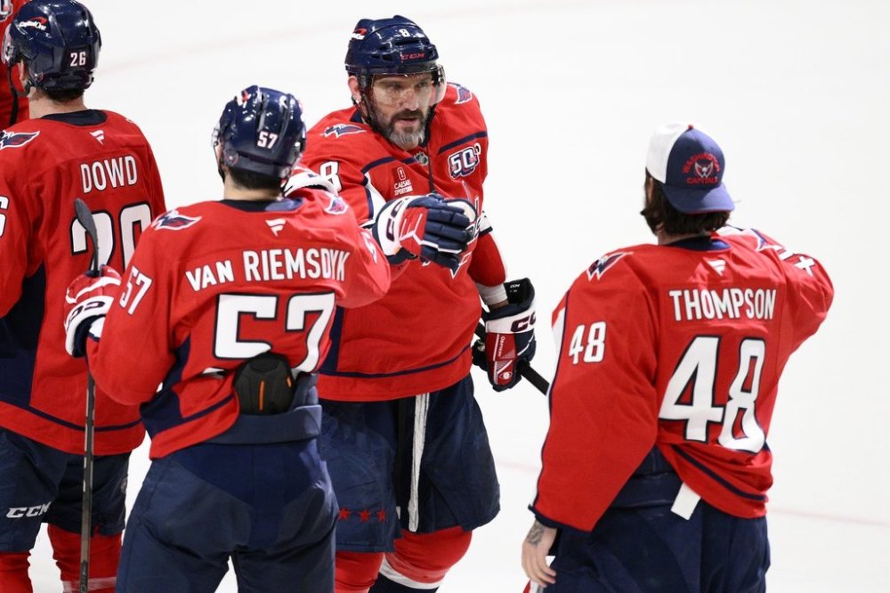 Washington Capitals left wing Alex Ovechkin (8) celebrates with defenseman Trevor van Riemsdyk (57) and goaltender Logan Thompson (48) after an NHL hockey game against the Philadelphia Flyers, Thursday, March 20, 2025, in Washington. (AP Photo/Nick Wass)