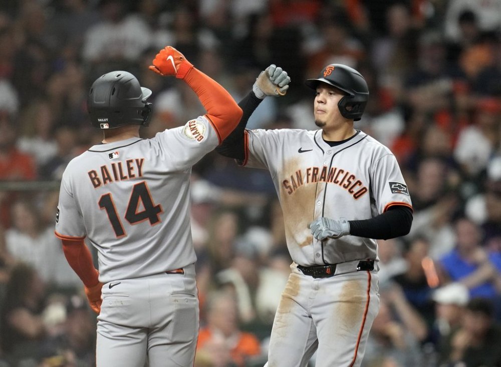San Francisco Giants' Wilmer Flores, right, celebrates his three-run home run against Houston Astros relief pitcher Luis Contreras with teammate Patrick Bailey (14) during the sixth inning of a baseball game Monday, March 31, 2025, in Houston. (AP Photo/Karen Warren)