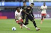 Canada's Ali Ahmed, left, trips as he fights for the ball against Mexico's Ernesto Vega, right, during the first half of a CONCACAF Nations League semifinal soccer match Thursday, March 20, 2025, in Inglewood, Calif. THE CANADIAN PRESS/AP, Etienne Laurent
