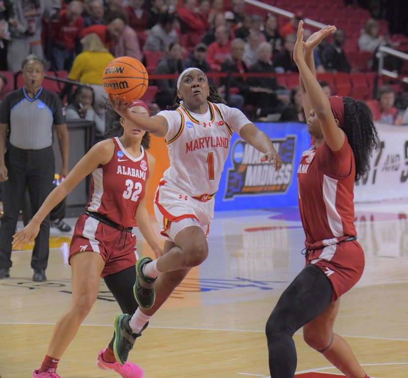 Maryland guard Sarah Te-Biasu powers into the paint past Alabama guard/forward Aaliyah Nye to score a layup in front of forward Christabel Ezumah in the second round of the NCAA college basketball tournament, Monday, March 24, 2025, in College Park, Md. (Karl Merton Ferron/The Baltimore Sun via AP)