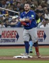 Toronto Blue Jays catcher Alejandro Kirk stands on third base after hitting an RBI triple off Tampa Bay Rays pitcher Garrett Cleavinger during the seventh inning of a baseball game on Saturday, Sept. 21, 2024, in St. Petersburg, Fla. (AP Photo/Steve Nesius)
