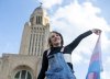 FILE - Gene Sorensen holds up a transgender flag in front of the Nebraska state Capitol during a Transgender Day of Visibility rally, March 31, 2023, in Lincoln, Neb. (Larry Robinson/Lincoln Journal Star via AP, file)