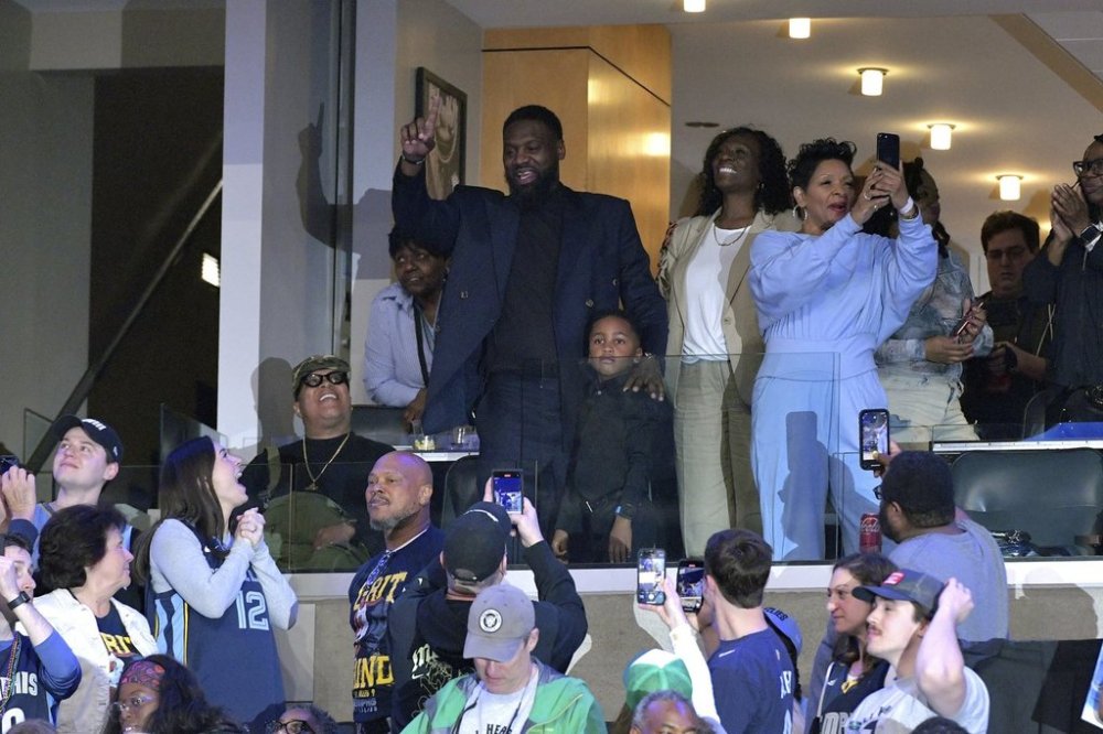 Former Memphis Grizzlies player Tony Allen, uper left, gestures to the crowd while standing with his family in the first half of an NBA basketball game between the Grizzlies and the Miami Heat, Saturday, March 15, 2025, in Memphis, Tenn. (AP Photo/Brandon Dill)