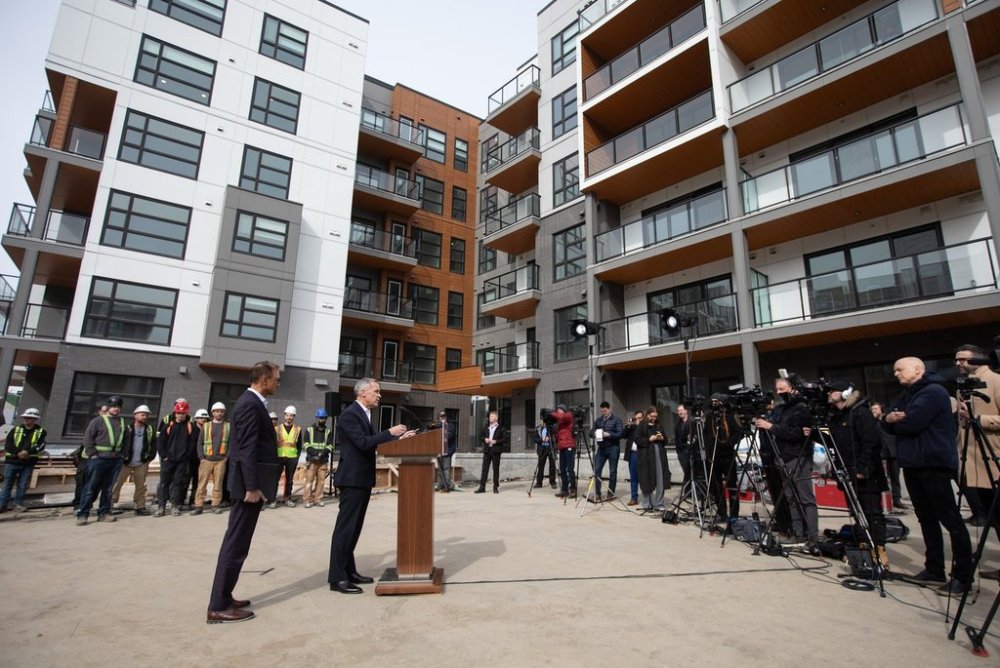 Prime Minister Mark Carney announces a new housing policy as Edmonton Mayor Amarjeet Sohi listens during a visit to Edmonton on Thursday, March 20, 2025. THE CANADIAN PRESS/Jason Franson