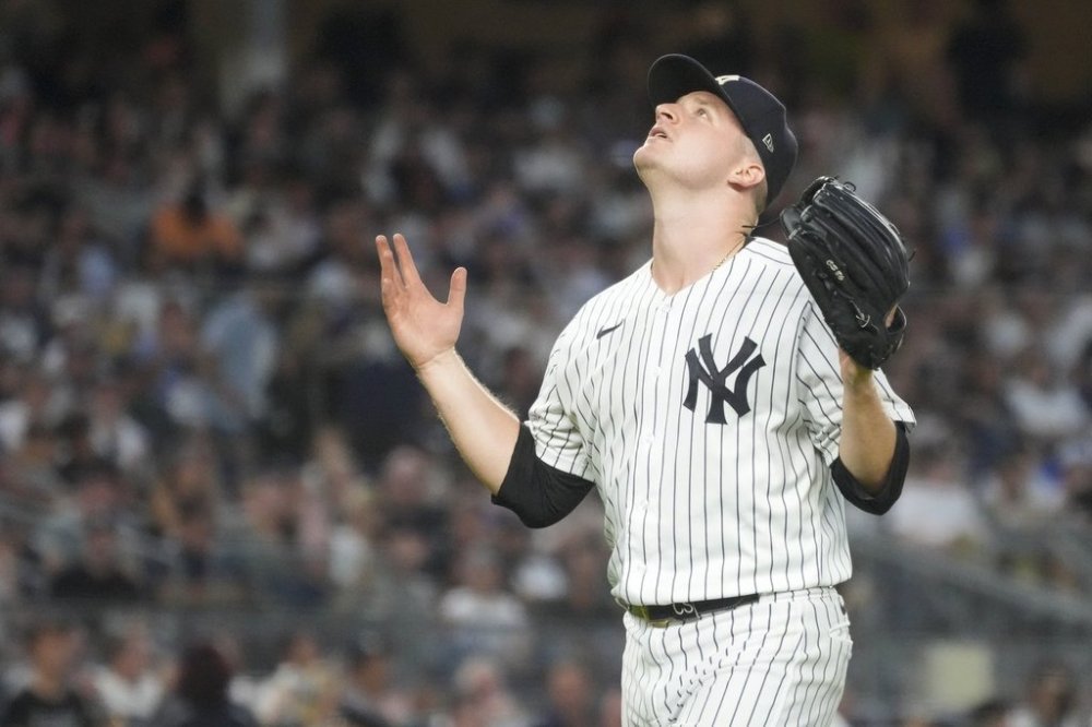 FILE - New York Yankees pitcher Clarke Schmidt reacts as he leaves the field after being removed from the game in the sixth inning of a baseball game against the Kansas City Royals, July 21, 2023, in New York. (AP Photo/Mary Altaffer, File)