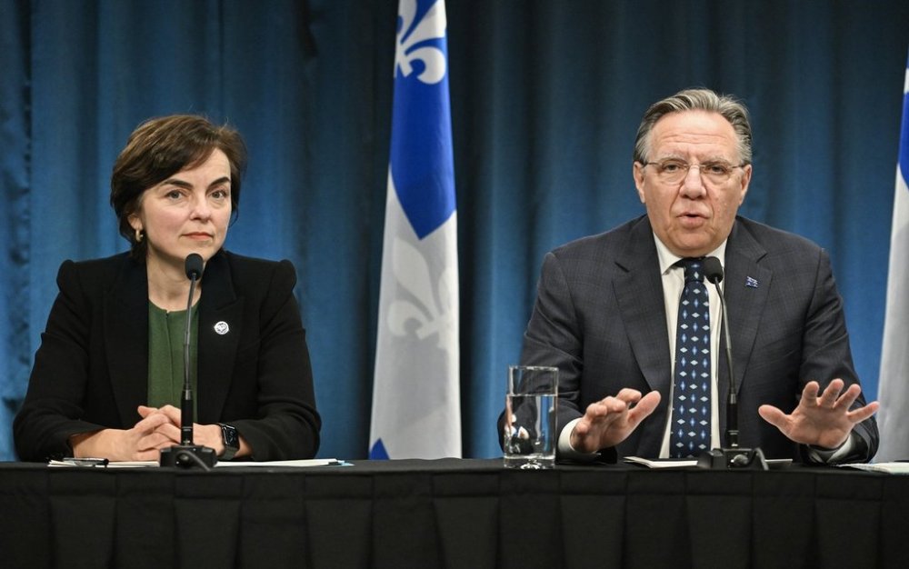 Quebec Economy Minister Christine Fréchette looks on as Quebec Premier François Legault speaks during a news conference in Montreal, Thursday, April 3 2025, following a virtual meeting with provincial counterparts and Prime Minister Mark Carney where they discussed U.S. President Donald Trump’s latest tariffs. THE CANADIAN PRESS/Graham Hughes
