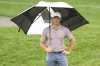 Rory McIlroy, of Northern Ireland, holds an umbrella on the 11th green during the final round of The Players Championship golf tournament Sunday, March 16, 2025, in Ponte Vedra Beach, Fla. (AP Photo/Chris O'Meara)