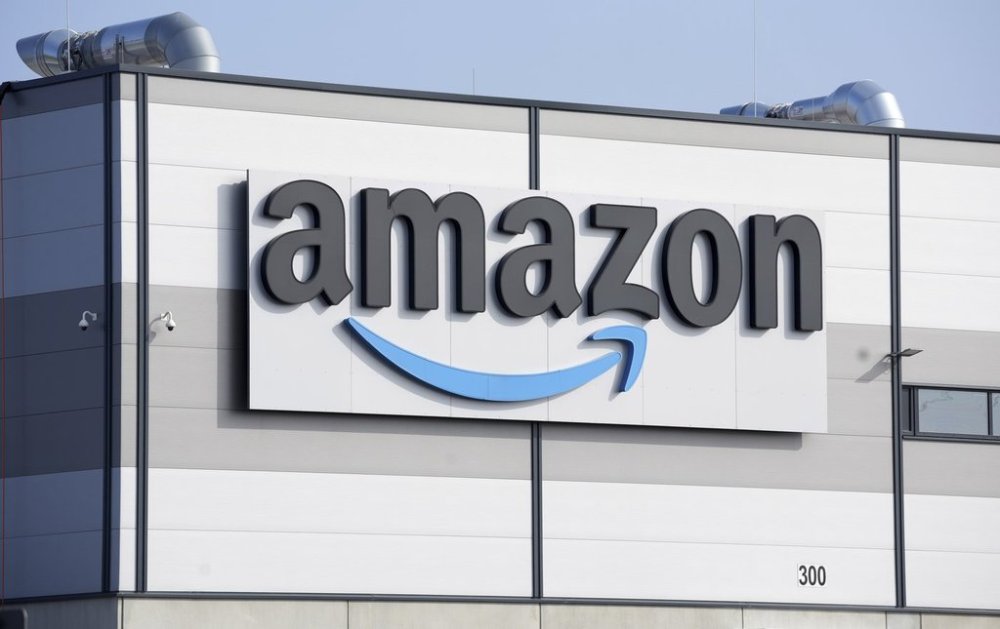 FILE - An Amazon company logo marks the facade of a building, March 18, 2022, in Schoenefeld near Berlin. AP Photo/Michael Sohn, File)