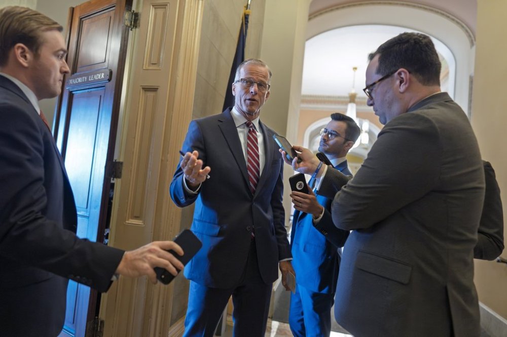 Reporters pose questions to Senate Majority Leader John Thune, R-S.D., as Republicans work to pass an interim spending bill that would avoid a partial government shutdown and keep federal agencies funded through September, at the Capitol in Washington, Tuesday, March 11, 2025. (AP Photo/J. Scott Applewhite)