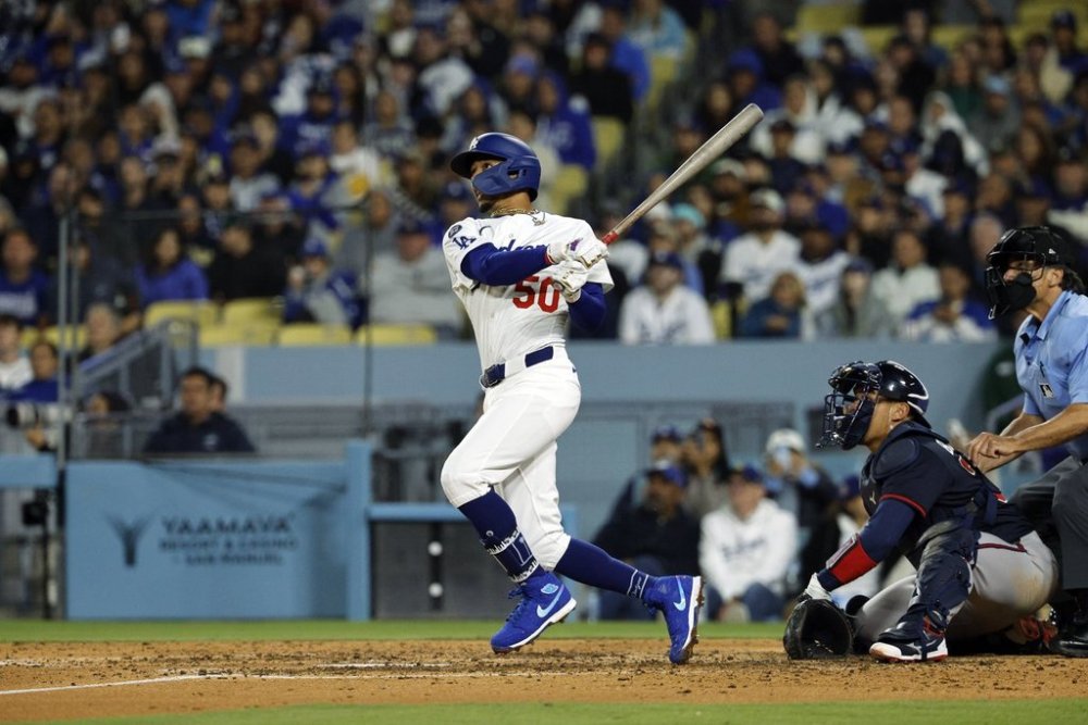 Los Angeles Dodgers' Mookie Betts hits a two-run home run against the Atlanta Braves during the sixth inning of a baseball game Tuesday, April 1, 2025, in, Los Angeles. (AP Photo/Kevork Djansezian)