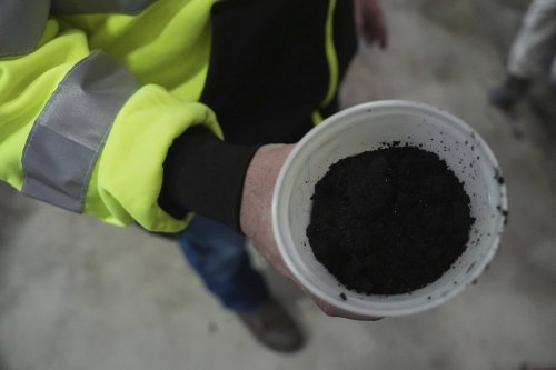 Josh Lutz displays some biosolids, also known as sewage sludge, Friday, March 7, 2025, at a wastewater treatment facility in Lockbourne, Ohio. (AP Photo/Joshua A. Bickel)