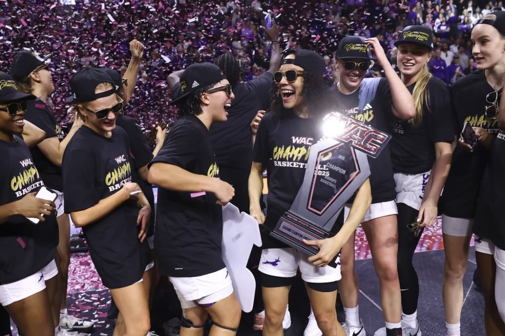 Grand Canyon guard Trinity San Antonio, center right, who was named most outstanding player, celebrates with Alyssa Durazo-Frescas, center left, after their victory over Texas-Arlington after an NCAA college basketball game in the championship of the Western Athletic Conference tournament Saturday, March 15, 2025, in Las Vegas. (AP Photo/Chase Stevens)