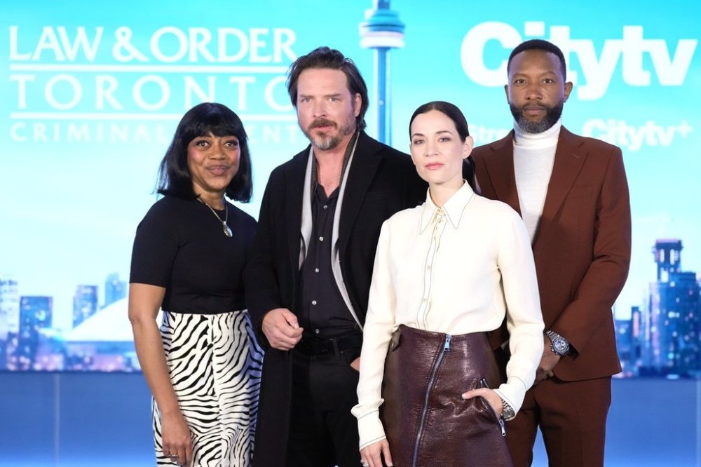 Cast members (left to right) Karen Robinson, Aden Young, Kathleen Munroe, and K.C. Collins pose for a photo at a press junket as they promote the television series