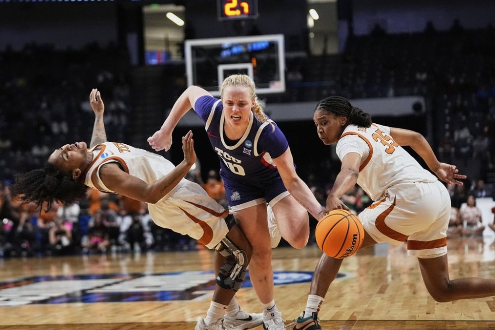TCU guard Hailey Van Lith (10) drives to the basket between Texas guard Rori Harmon and forward Madison Booker (35) during the second half in the Elite Eight of the NCAA college basketball tournament, Monday, March 31, 2025. in Birmingham, Ala. (AP Photo/Gerald Herbert)