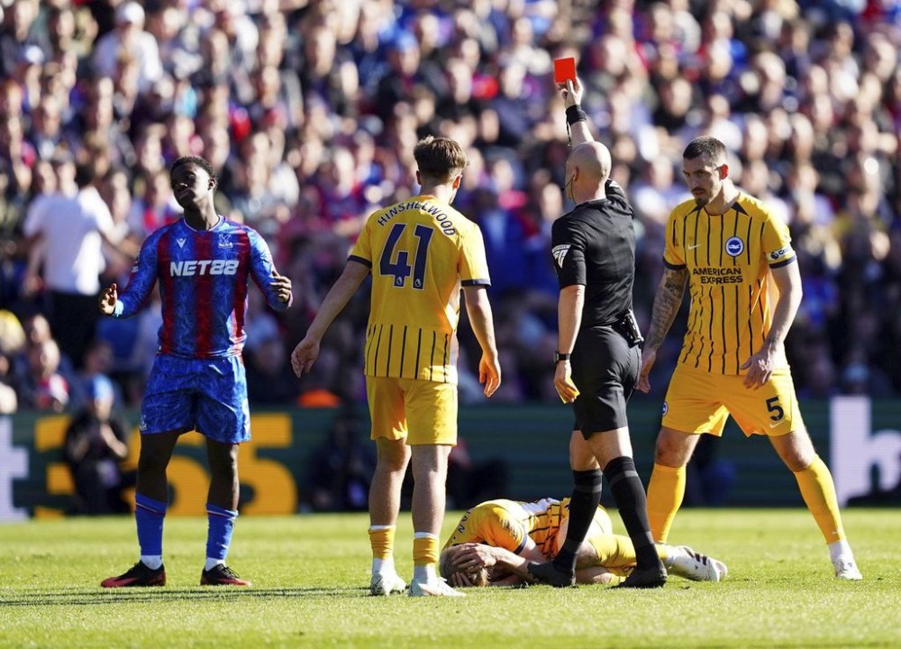 Referee Anthony Taylor shows Crystal Palace's Eddie Nketiah, left a red card, during the English Premier League soccer match between Crystal Palace and Brighton and Hove Albion, at Selhurst Park, London, Saturday April 5, 2025. (James Manning/PA via AP)