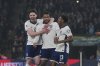 England's Reece James, centre, celebrates with teammates after scoring his side's opening goal during a World Cup qualifying soccer match between England and Latvia at Wembley stadium in London, Monday, March 24, 2025. (AP Photo/Kin Cheung)