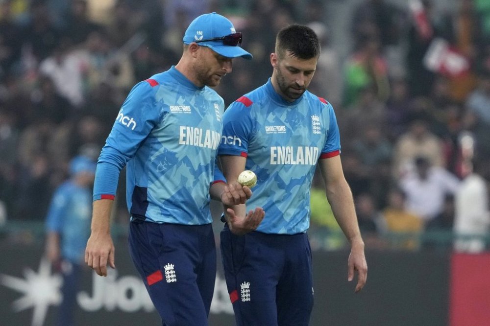 England's Mark Wood, right, chats with Jos Buttler during the ICC Champions Trophy cricket match between Afghanistan and England, in Lahore, Pakistan, Wednesday, Feb. 26, 2025. (AP Photo/K.M. Chaudary)