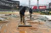The grounds crew works on the field during a rain delay in the seventh inning of a baseball game between the Los Angeles Angels and the Chicago White Sox in Chicago, Sunday, March 30, 2025. (AP Photo/Nam Y. Huh)