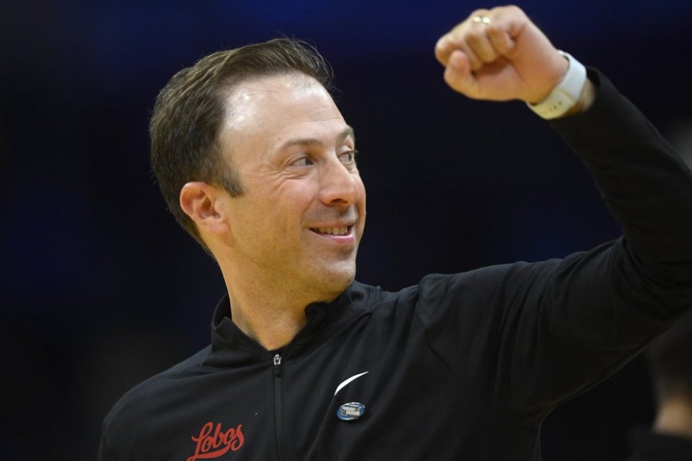 New Mexico head coach Richard Pitino celebrates a win against Marquette in the first round of the NCAA college basketball tournament, Friday, March 21, 2025, in Cleveland. (AP Photo/David Richard)