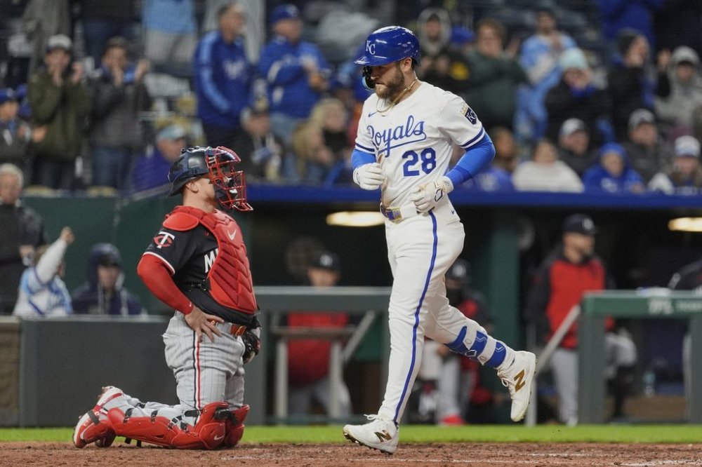 Kansas City Royals' Kyle Isbel (28) crosses the plate past Minnesota Twins catcher Christian Vazquez after hitting a solo home run during the sixth inning of a baseball game, Monday, April 7, 2025, in Kansas City, Mo. (AP Photo/Charlie Riedel)