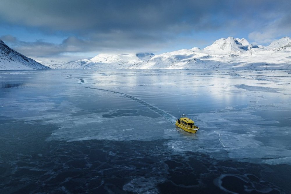 A boat travels though a frozen sea inlet outside in Nuuk, Greenland, March 6, 2025. (AP Photo/Evgeniy Maloletka)