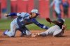 Cleveland Guardians' Brayan Rocchio, right, is caught stealing second by Kansas City Royals shortstop Bobby Witt Jr., left, during the second inning of a baseball game, Saturday, March 29, 2025, in Kansas City, Mo. (AP Photo/Charlie Riedel)