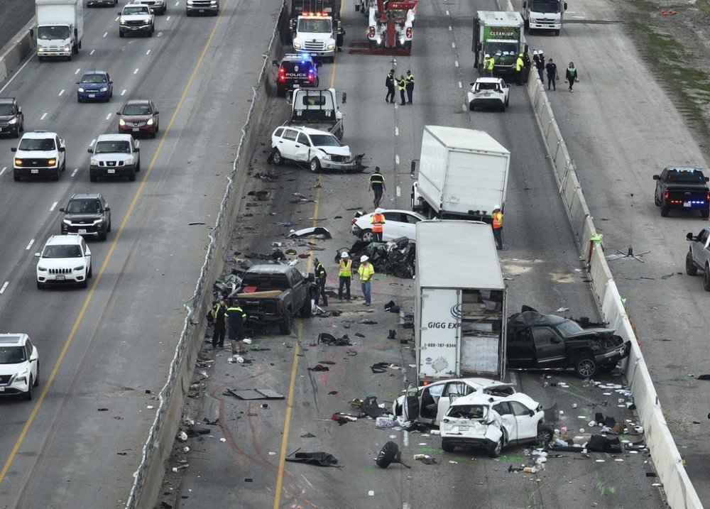 Officials examine the aftermath of a fatal crash on I-35 southbound near Parmer Lane Friday March 14, 2025 in Austin, Texas. (Jay Janner/Austin American-Statesman via AP)
